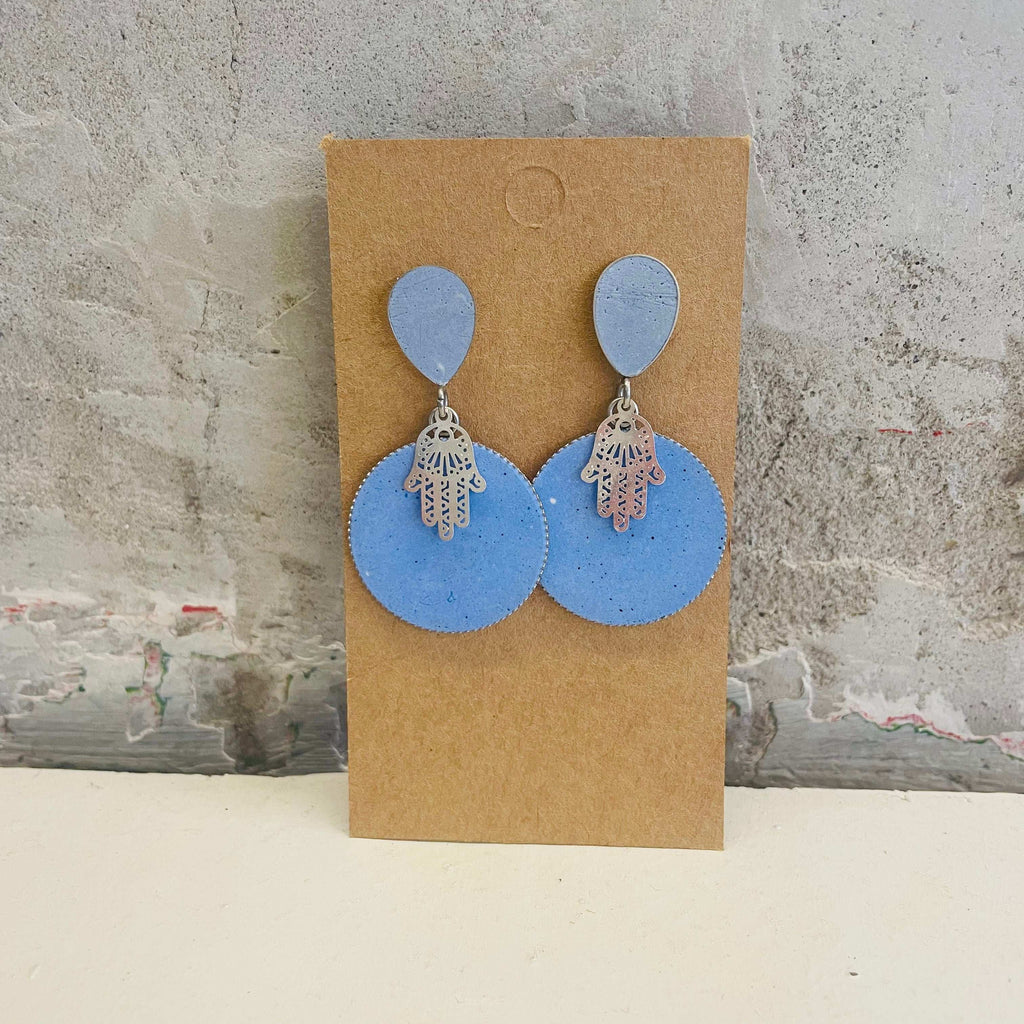 Chamsa earrings with a blue, round concrete piece by Stef.co